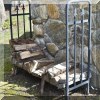 L08. Metal wood rack and wood. 